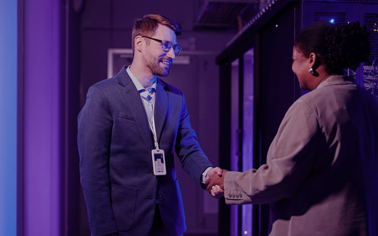 partners shaking hands in a data center