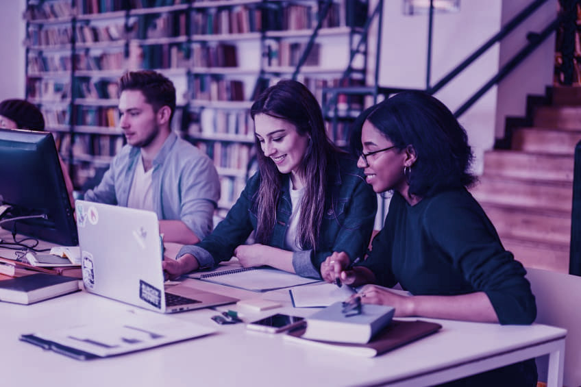 university students studying in a library