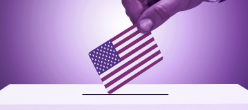 man inserting US flag into ballot box