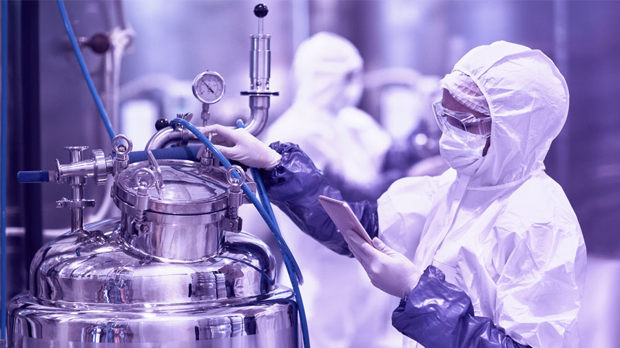 female worker wearing protective suit in chemical plant