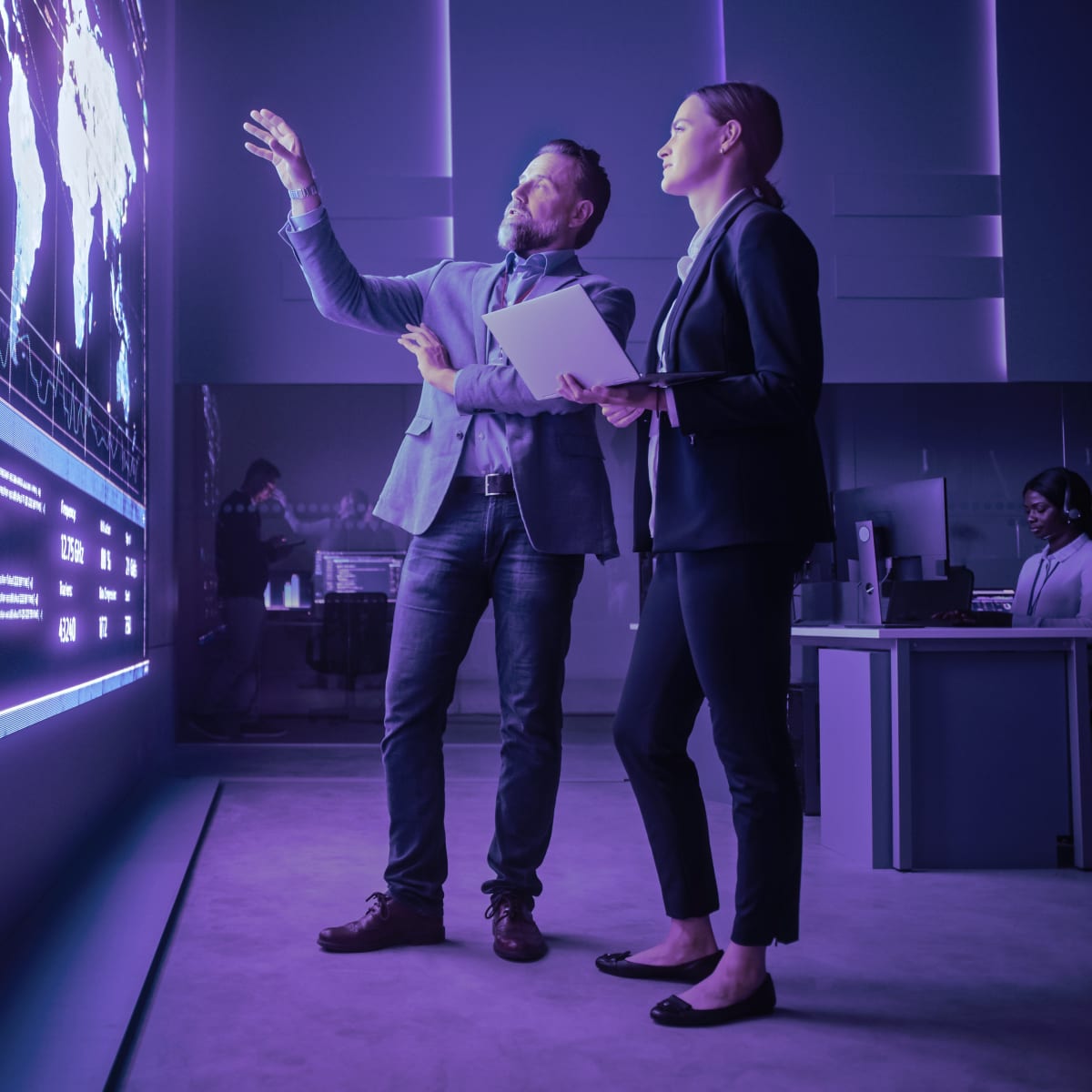 engineers talking while using big screen display